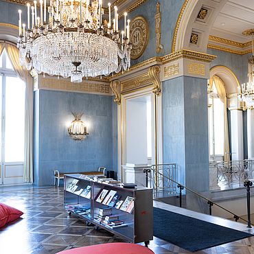 Hall with a chandelier and information desk