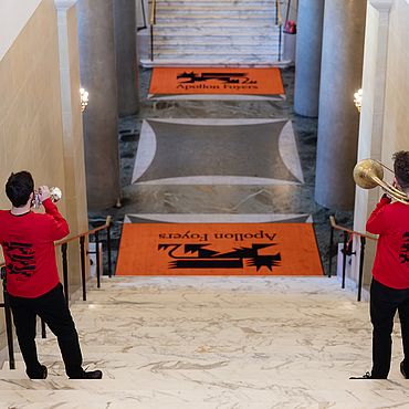 Two trumpeters on a staircase
